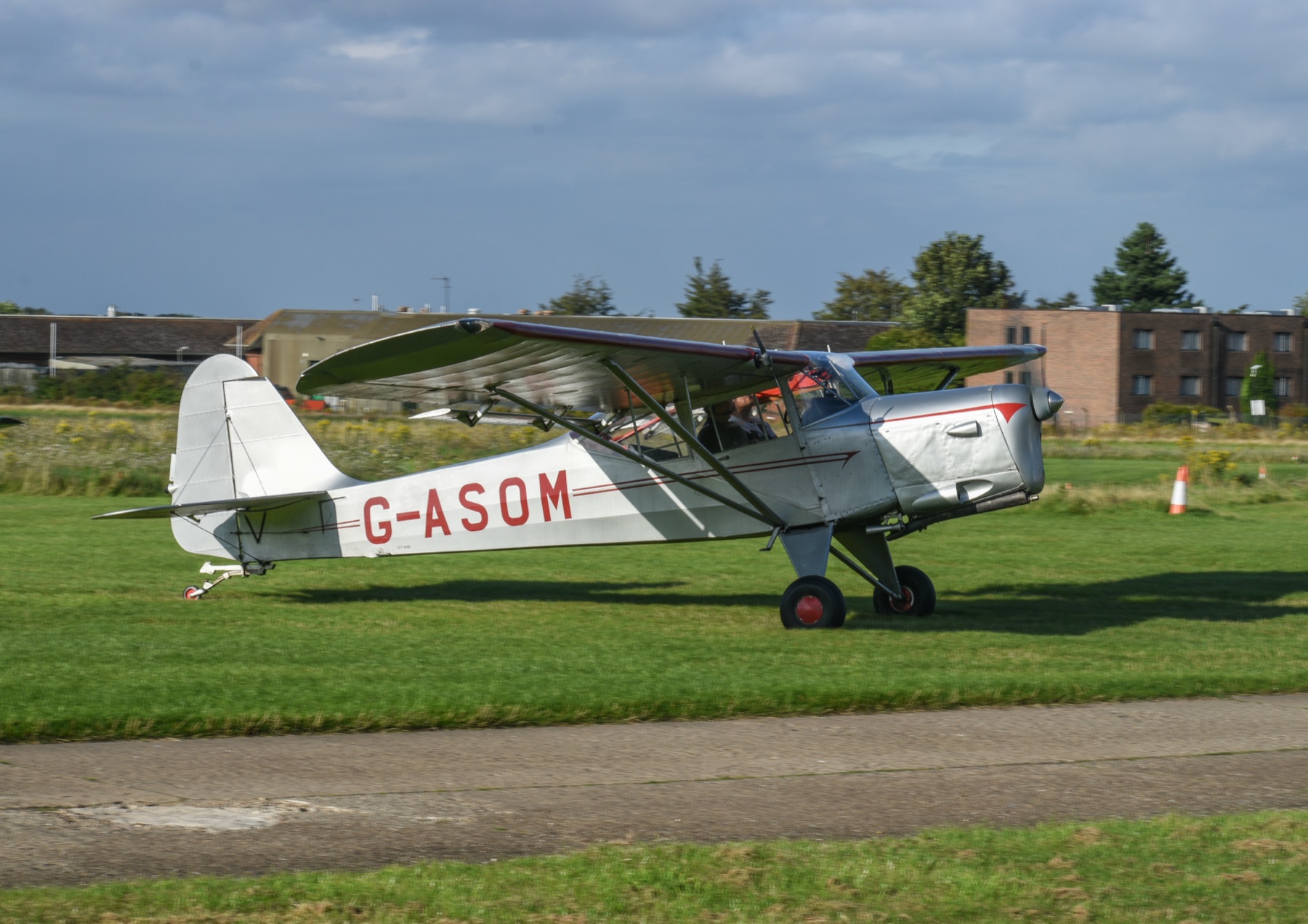 An Auster taxiing on the grass at Rochester Airport