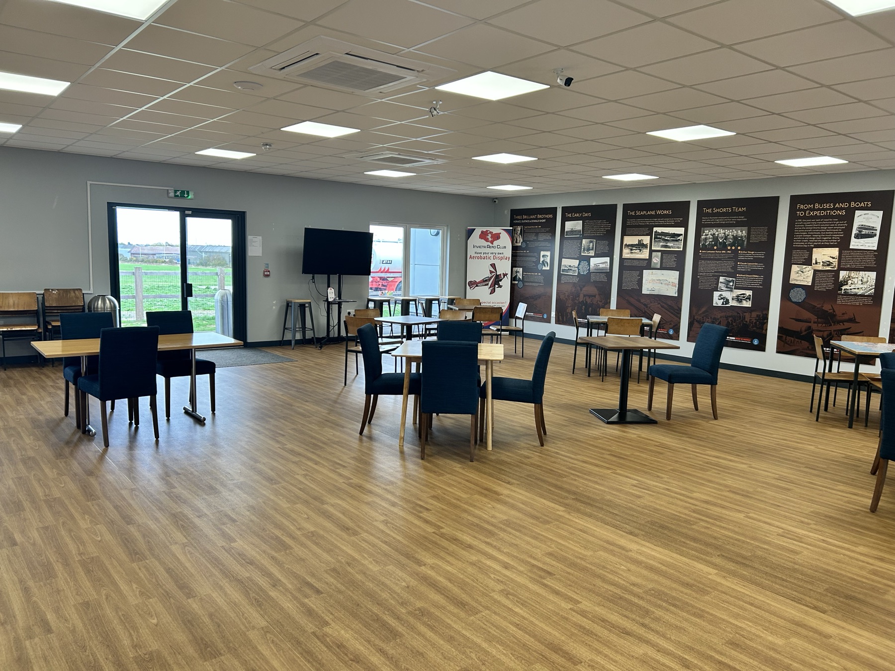 Inside Ground Control Coffee, with the airport's heritage displays and the airfield through the windows