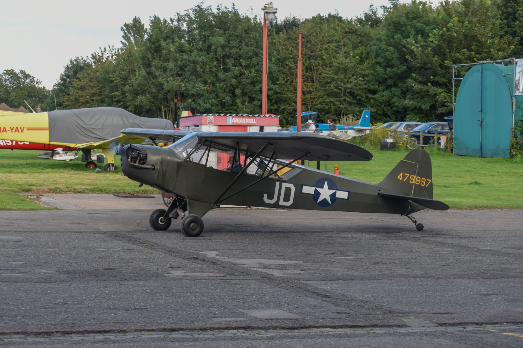 A Piper Cub on the apron beside the fuel bay at Rochester Airport