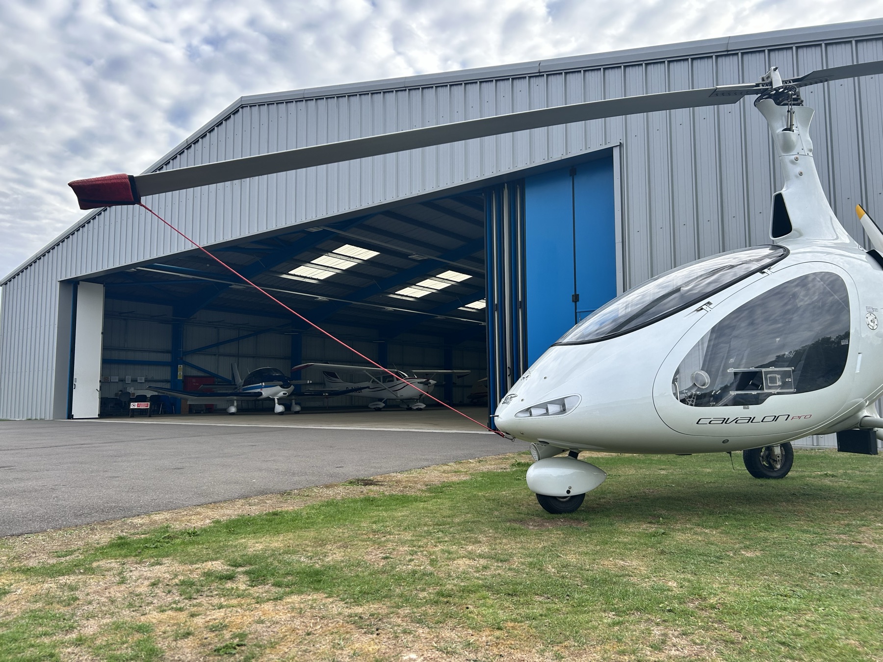 A Cavalon gyrocopter outside the hangar at Rochester Airport