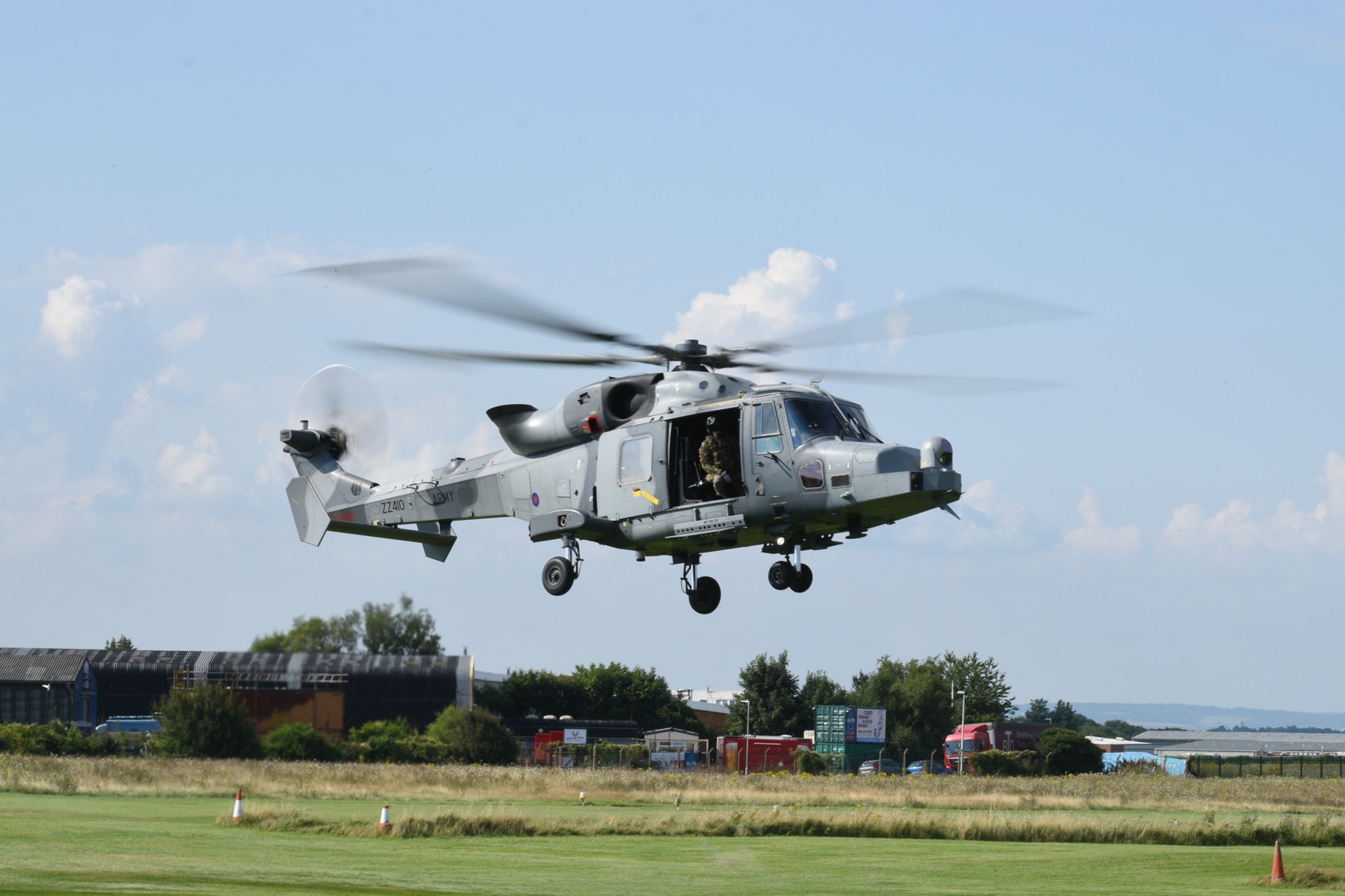 A Wildcat helicopter hovering over the grass at Rochester Airport